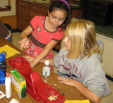 Two young girls working on project 