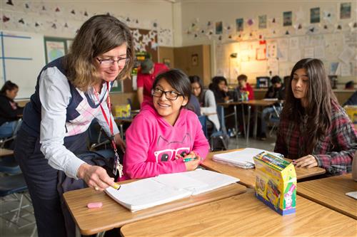 Female teacher with 2 female teenage students